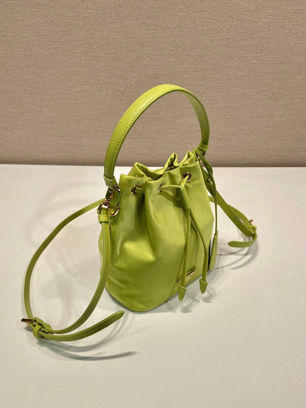 PRADA BUCKET BAG 19 IN APPLE GREEN RE-NYLON AND SAFFIANO LEATHER HANDLE