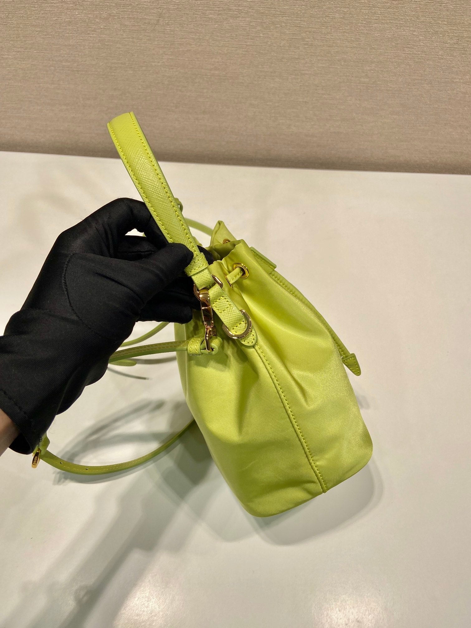 PRADA BUCKET BAG 19 IN APPLE GREEN RE-NYLON AND SAFFIANO LEATHER HANDLE