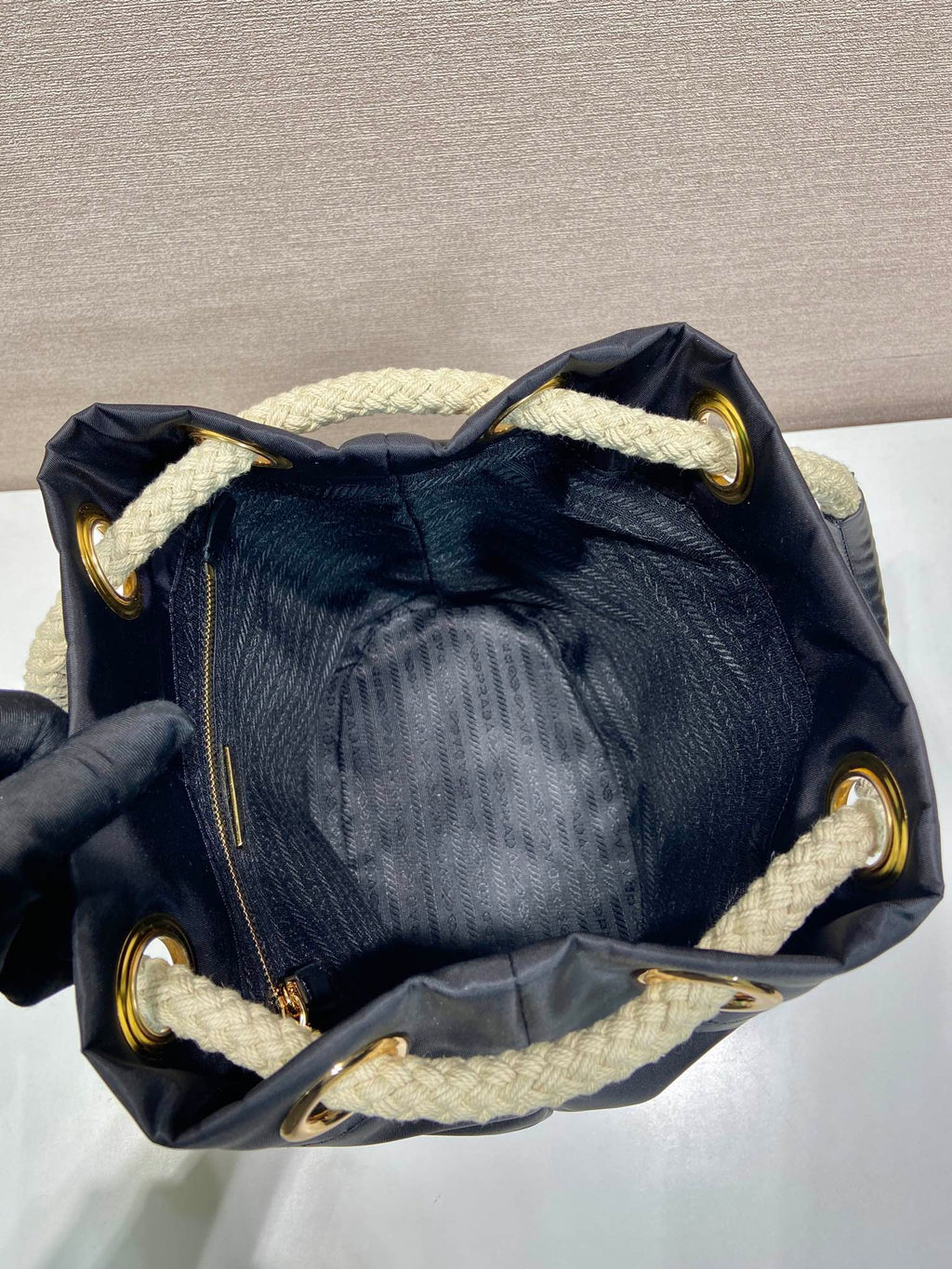 PRADA BUCKET BAG 28 IN BLACK RE-NYLON GOLD LOGO