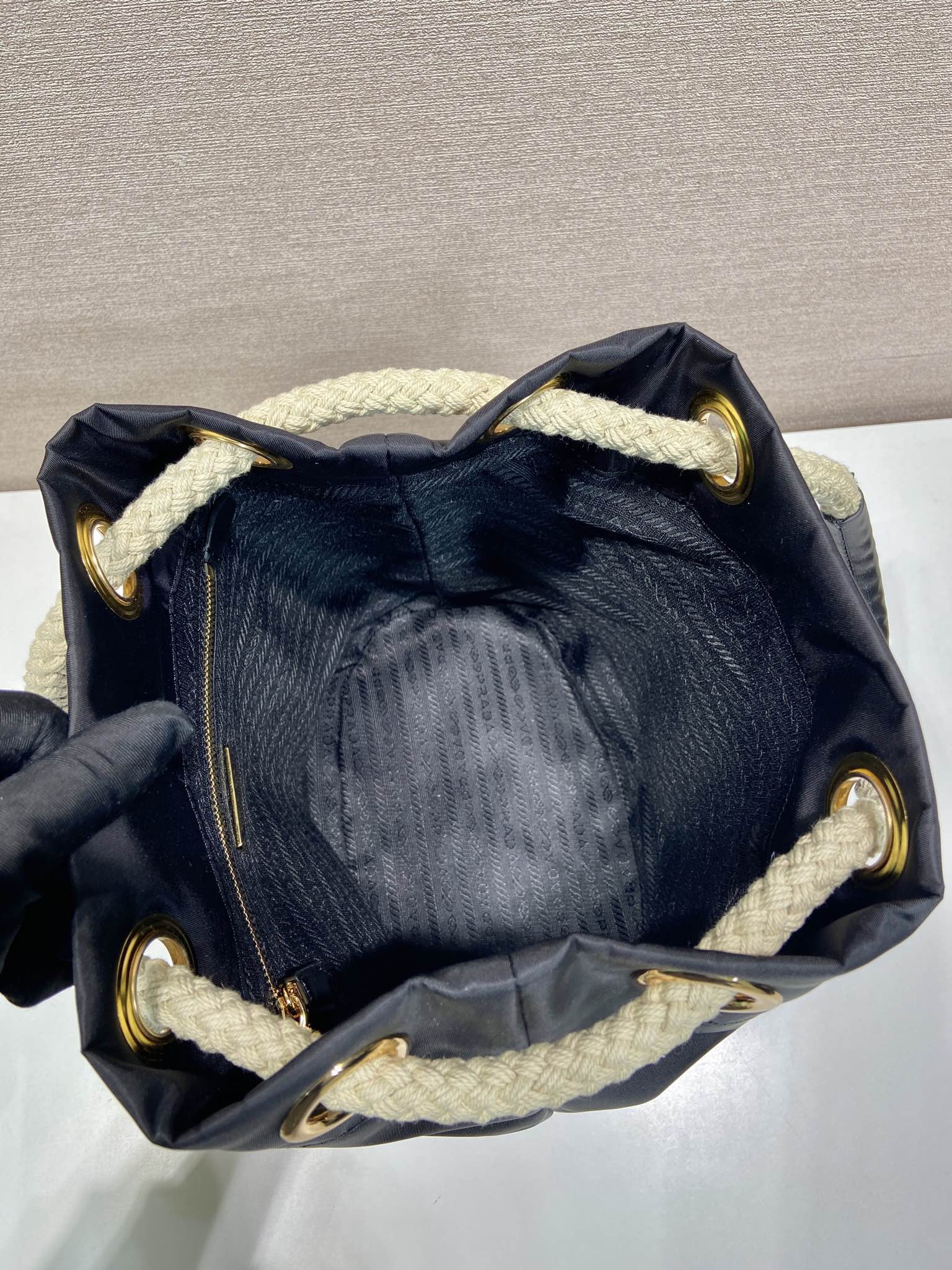 PRADA BUCKET BAG 28 IN BLACK RE-NYLON GOLD LOGO