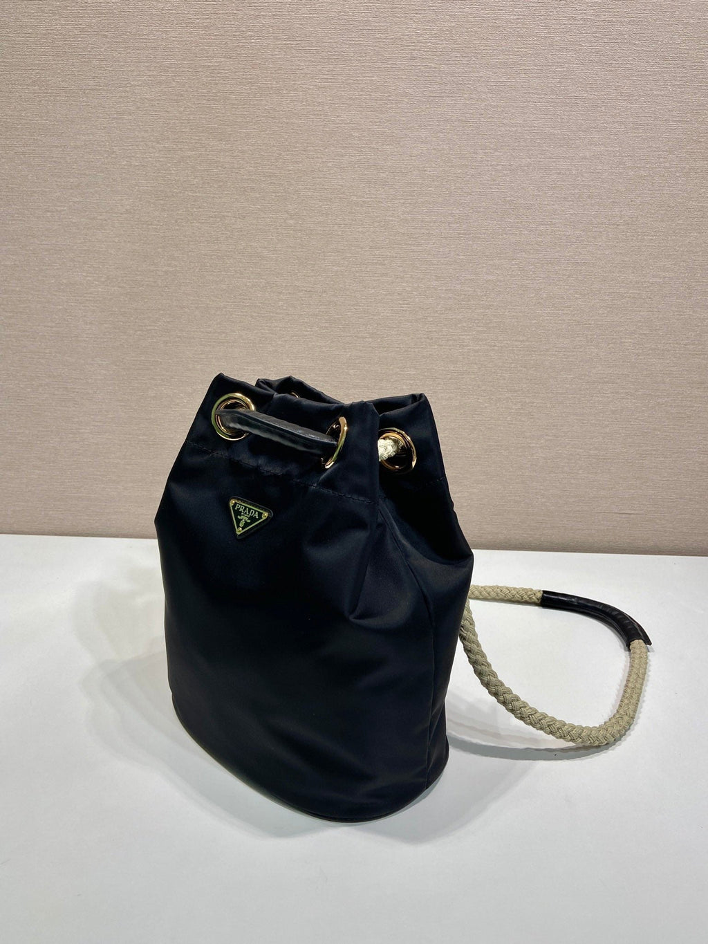 PRADA BUCKET BAG 28 IN BLACK RE-NYLON GOLD LOGO