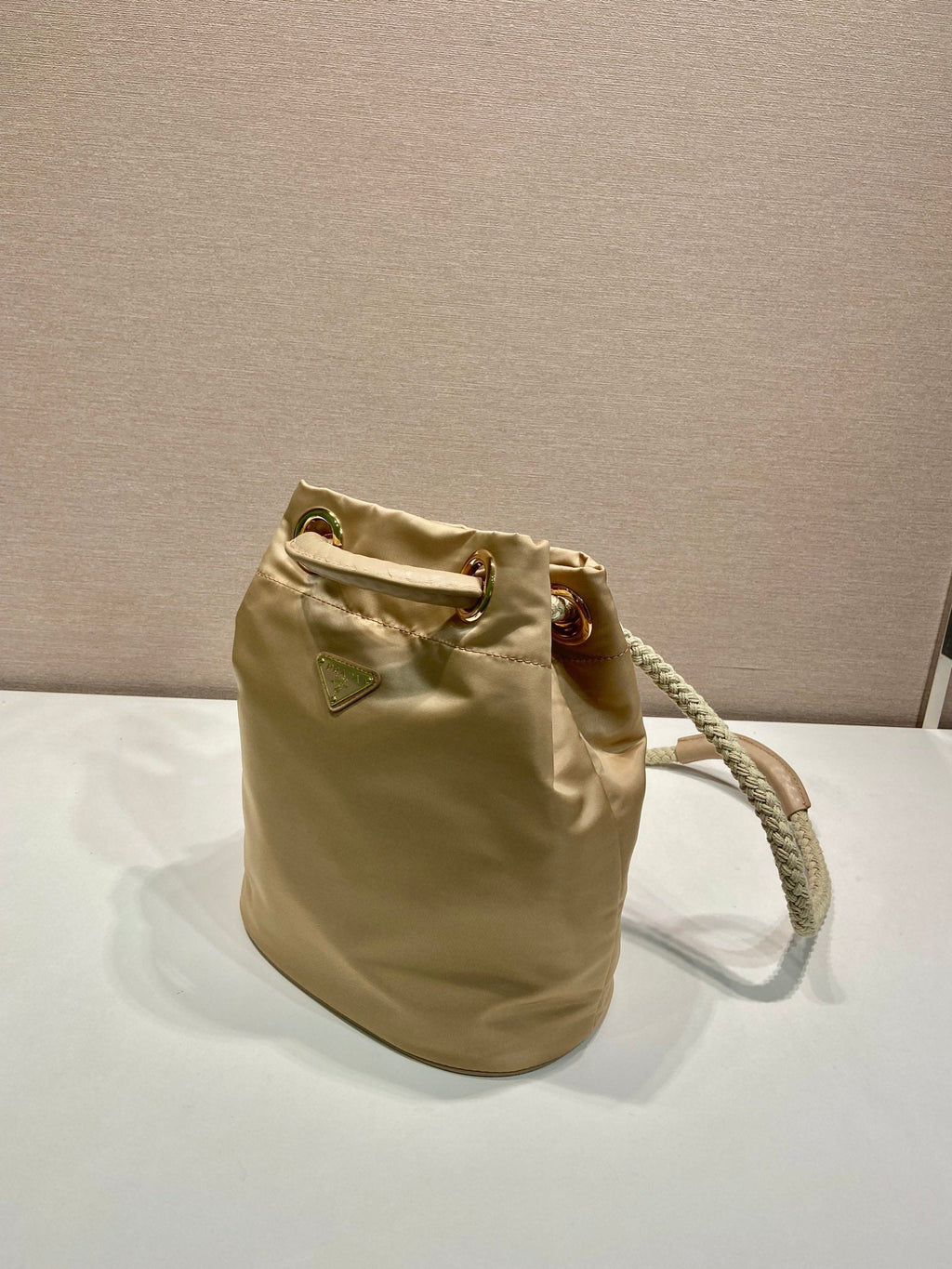 PRADA BUCKET BAG 28 IN BEIGE RE-NYLON GOLD LOGO