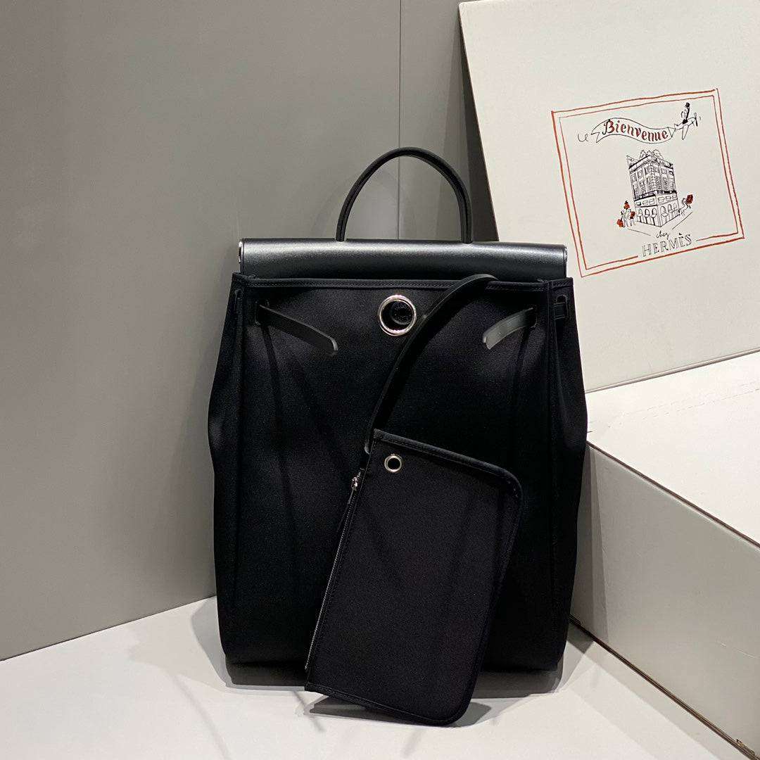 HERMES HERBAG A DOS ZIP RETOURNE BACKPACK 29 IN BLACK CANVAS AND CALFSKIN