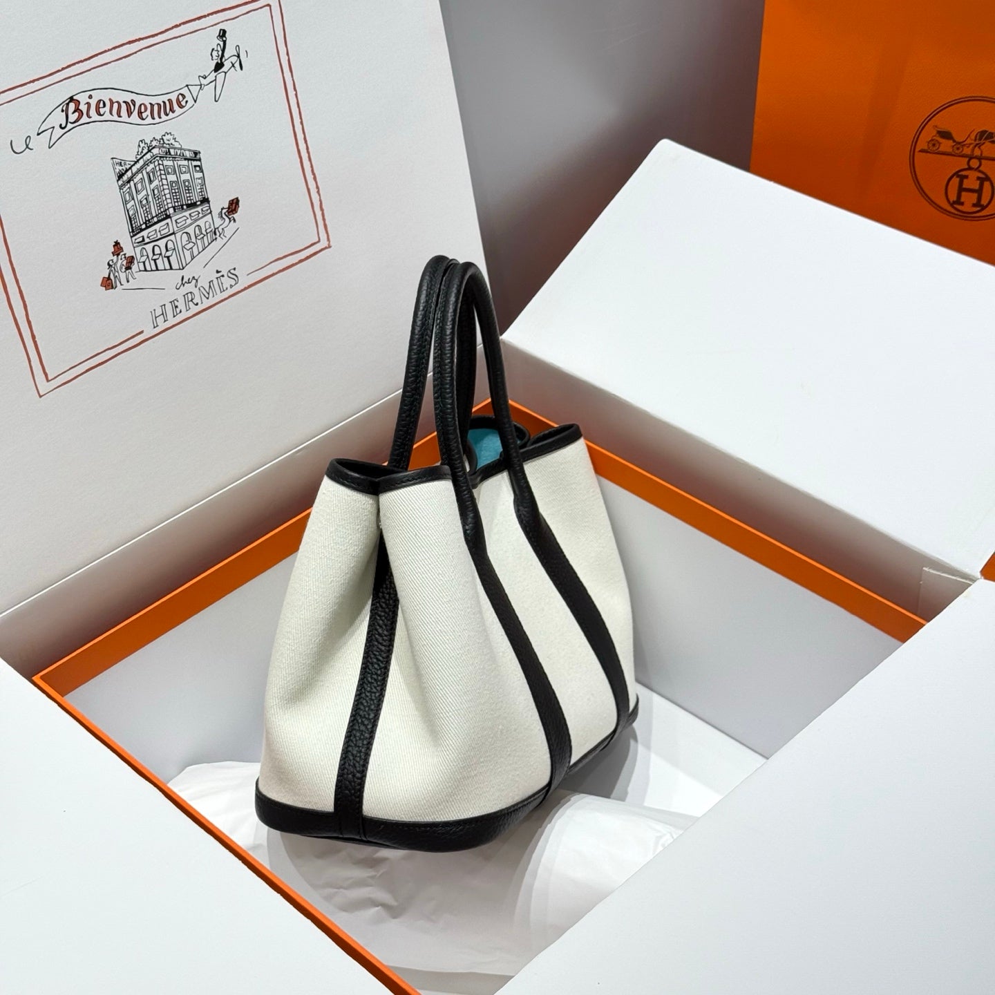 HERMES GARDEN PARTY 30CM IN WHITE TOILETS COTTON CANVAS AND BLACK CALFSKIN SKY BLUE CANVAS ON SIDE OTHER
