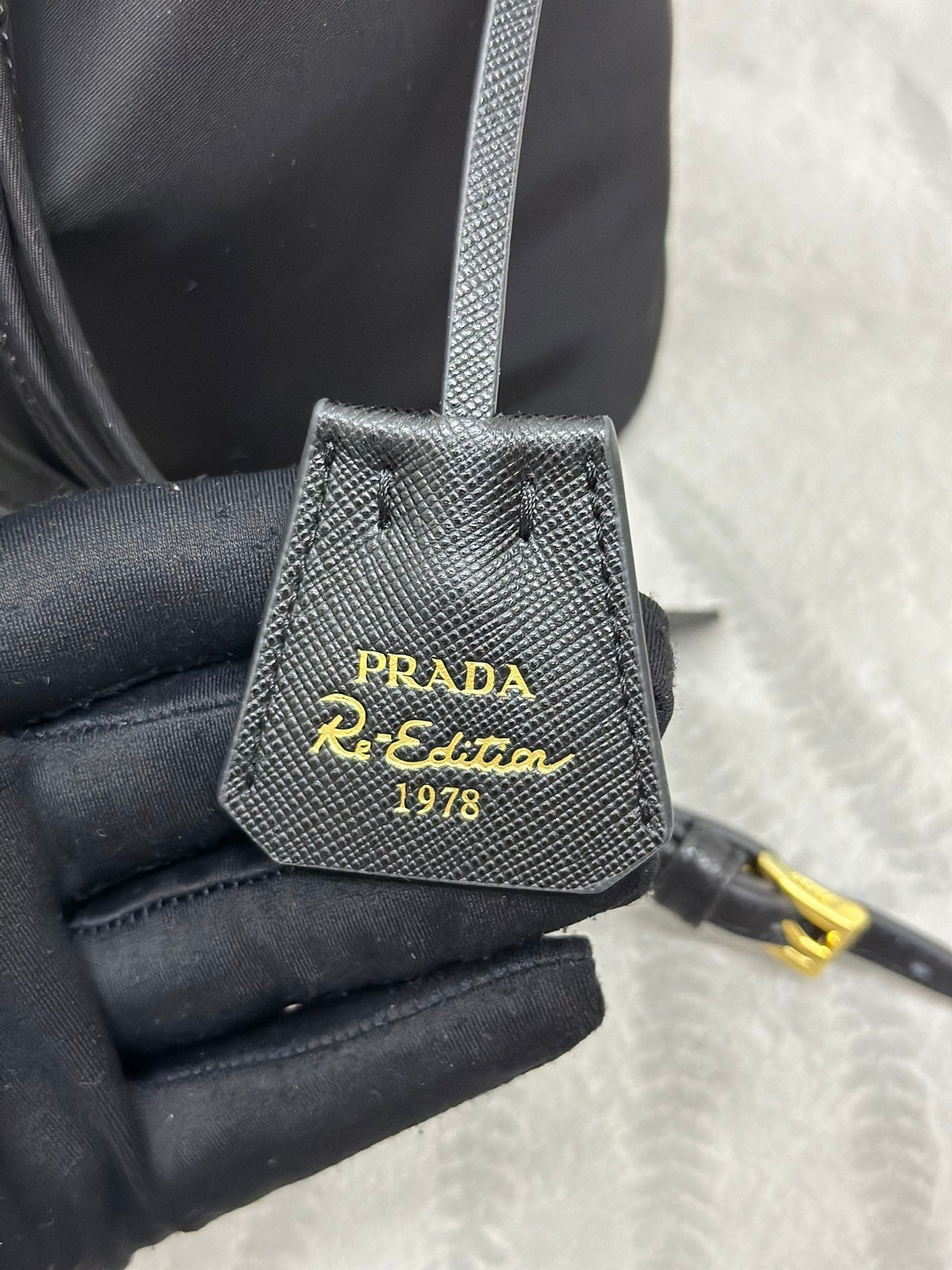 PRADA BUCKET BAG 19 IN BLACK RE-NYLON AND CALFSKIN HANDLE